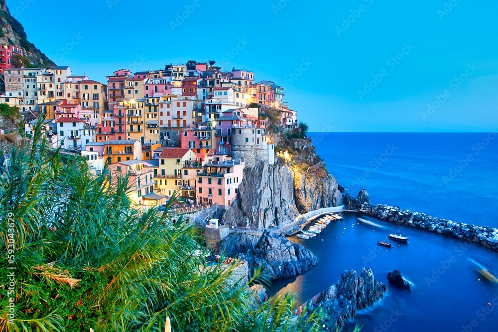 Colorful building of the Manarolas town in Cinque Terre Italy surrounded by the calm sea