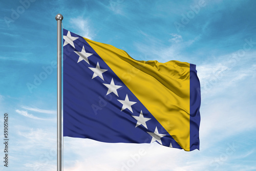 Bosnia and Herzegovina national flag cloth fabric waving on beautiful sky Background.