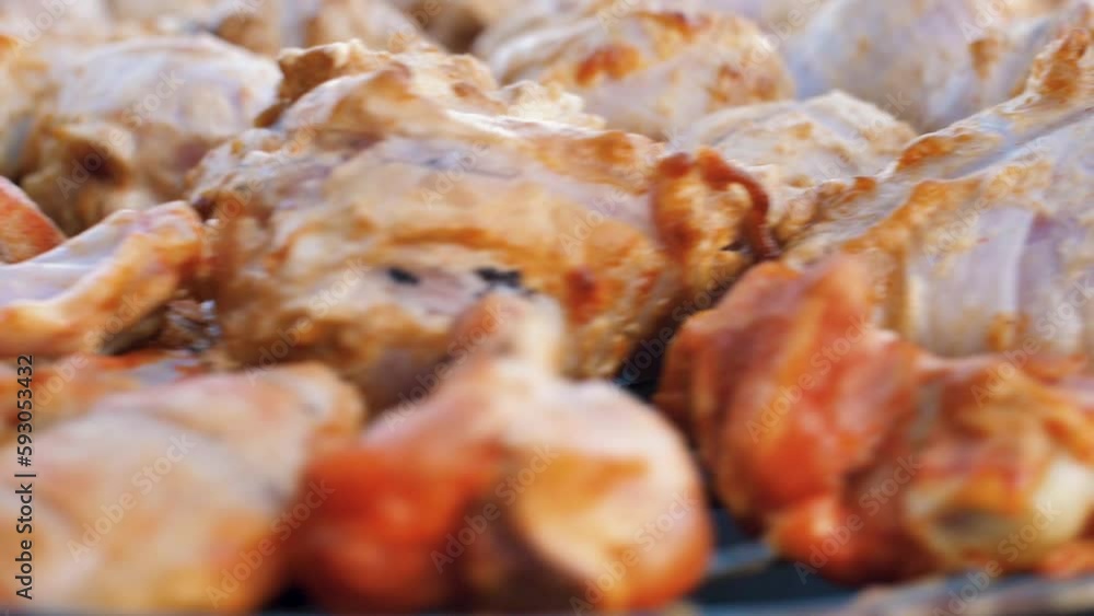 Meat on the moving grill. Roasting shish kebabs on the grill. Meat on the moving grill. Roasting shish kebabs on the grill.