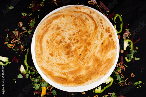 Peshawari paratha served in dish isolated on dark background top view of indian spices food