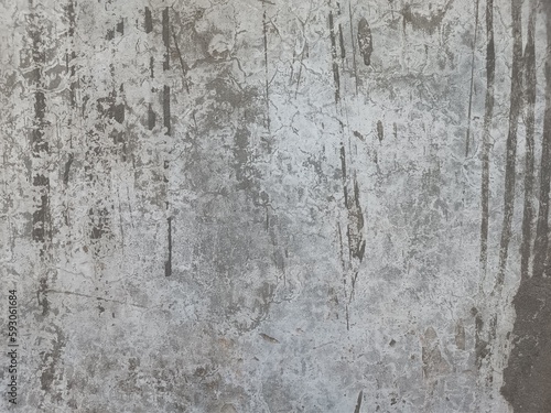 Wall Rough fragment Texture with scratches and cracks.Stucco white wall background.Grey background vintage color and sponged distressed texture in soft blended brush strokes with white grunge. © vandana