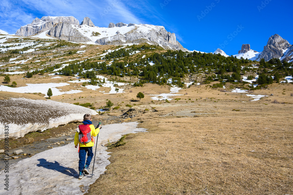 hikers walking in the snowy mountains of the pyrenees