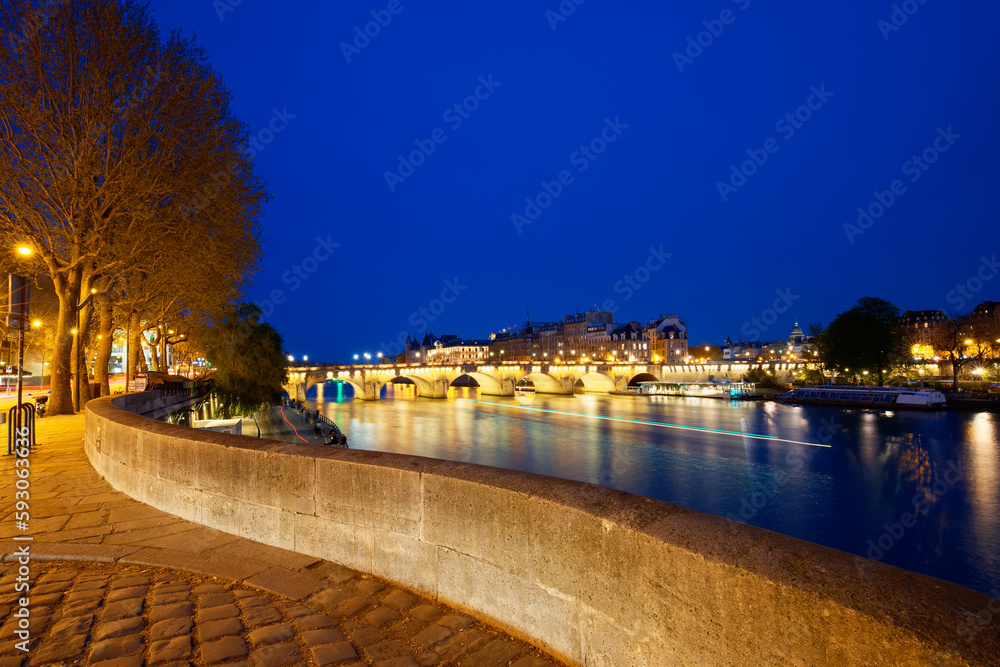 CItyscape of downtown with Pont Neuf Bridge and River Seine at night , Paris.