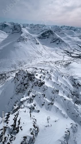 Drone flying thru Norwegian snowy mountains and alps