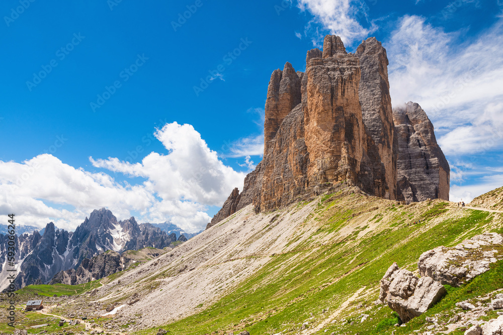 Beautiful sunny day in Dolomites mountains. View on Tre Cime di Lavaredo with shelter. Three famous mountain peaks