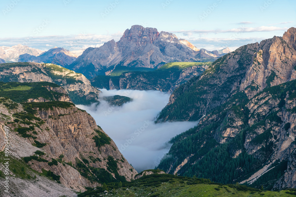 Mountain canyon filled with clouds at sunrise in Dolomites, Alps, Italy. Italian mountain landscape