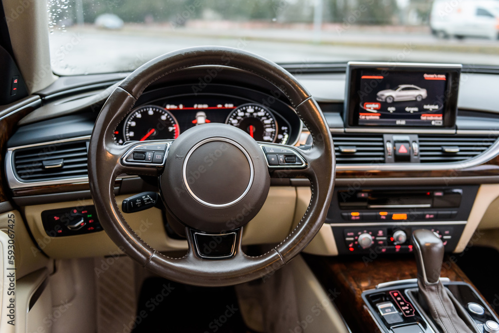 Luxury modern car interior business class. Steering wheel, shift lever ...