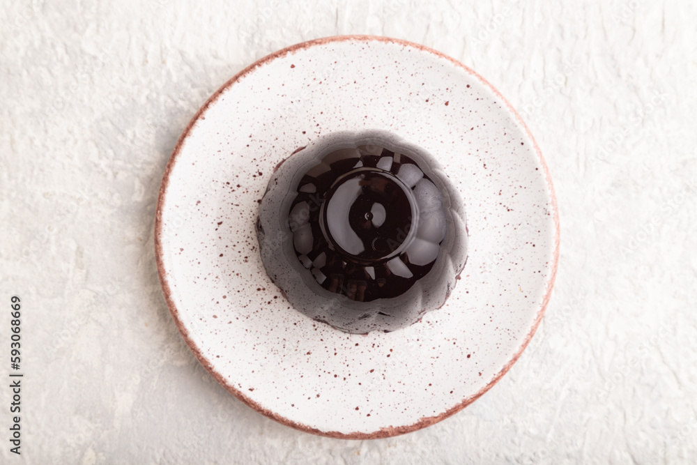 Black currant and grapes jelly on gray concrete. top view.