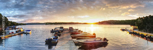 Small fishing boats at dock in the morning sunrise with a wonderful sky 
