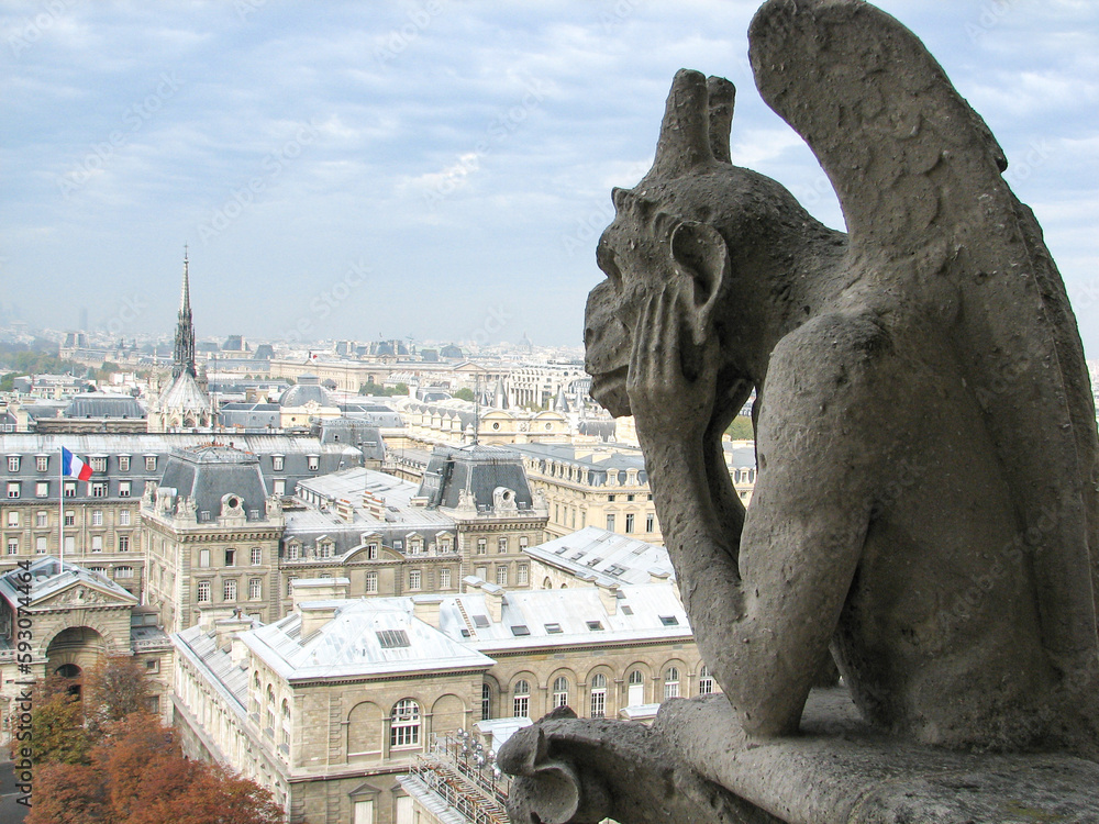 Paris, France - The legendary gargoyles of Notre-Dame-de-Paris, stone creatures intended to protect the church from malevolent spirits, overlooking the city.  Image has copy space.