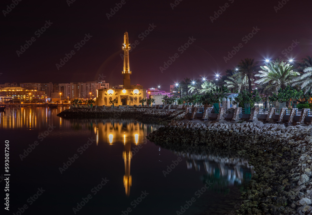 Hanan Kanoo Mosque in the evening lights on the shore of Persian Gulf, Manama, Bahrain