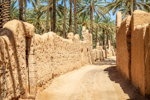 Al Ula ruined old town street with palms along the road, Saudi Arabia