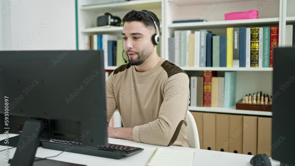 Young arab man student doing video call writing on notebook at university classroom Young arab man student doing video call writing on notebook at university classroom