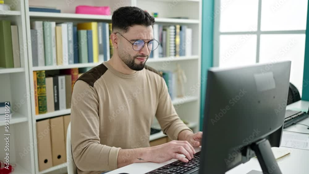 Young arab man student tired studying with computer at university classroom