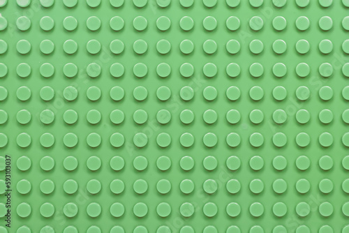 Green plastic constructor blocks plate seamless pattern flat design. Full frame.