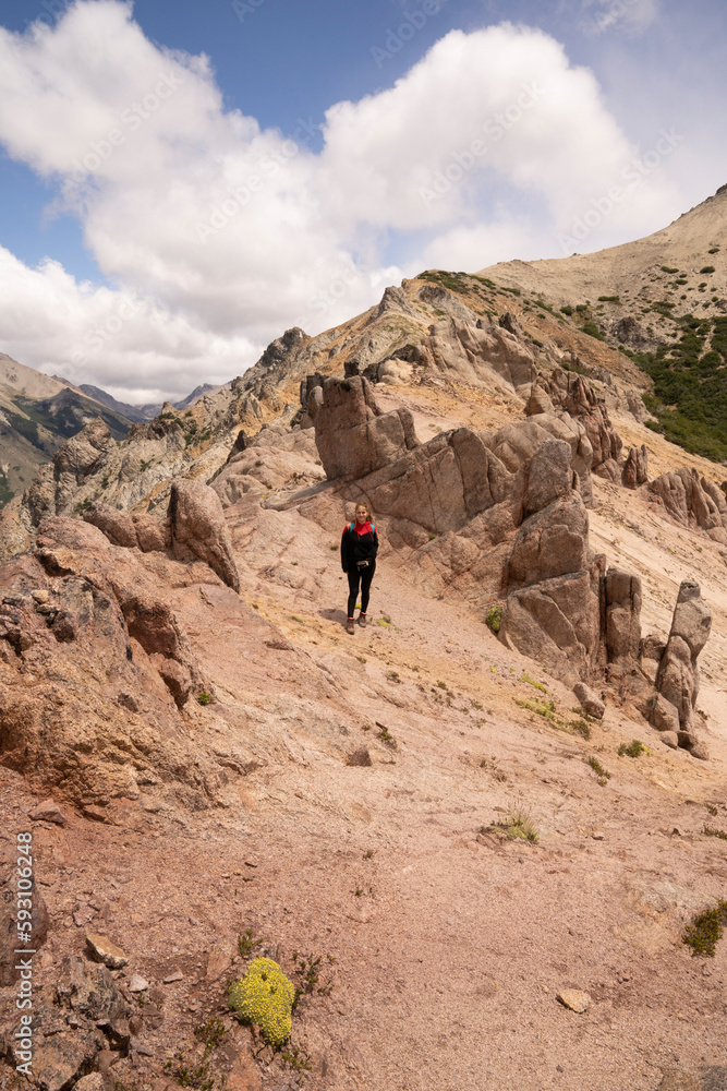 Hiking in the top of the mountain. Portrait of a young man trekking along the Bella Vista hill rocky peak in Bariloche, Patagonia Argentina. Hiking in the top of the mountain. Portrait of a young man trekking along the Bella Vista hill rocky peak in Bariloche, Patagonia Argentina.