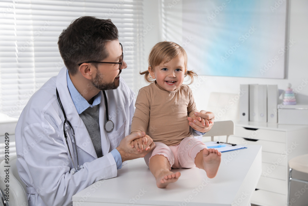 Pediatrician examining cute little baby in clinic Pediatrician examining cute little baby in clinic
