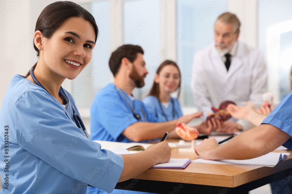 Portrait of young intern wearing uniform on lecture in university