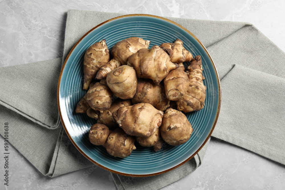 Jerusalem artichokes on light grey marble table, top view Jerusalem artichokes on light grey marble table, top view