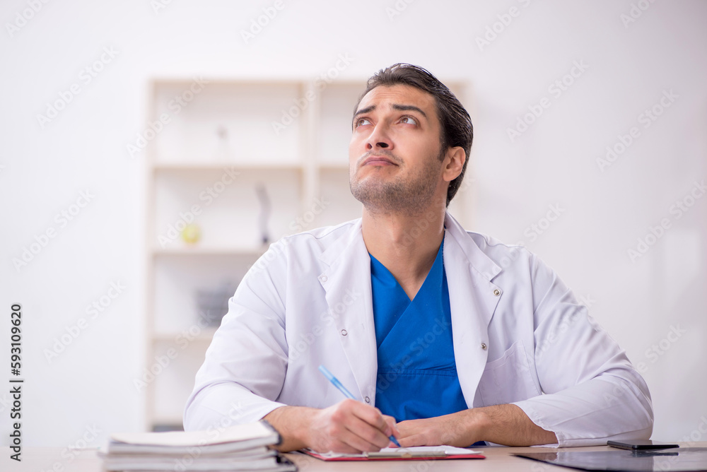 Young male doctor working in the clinic Young male doctor working in the clinic