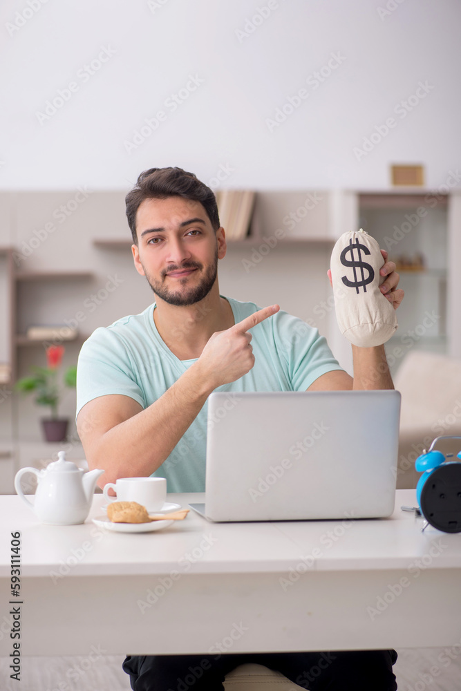 Young male freelancer in remuneration concept Young male freelancer in remuneration concept