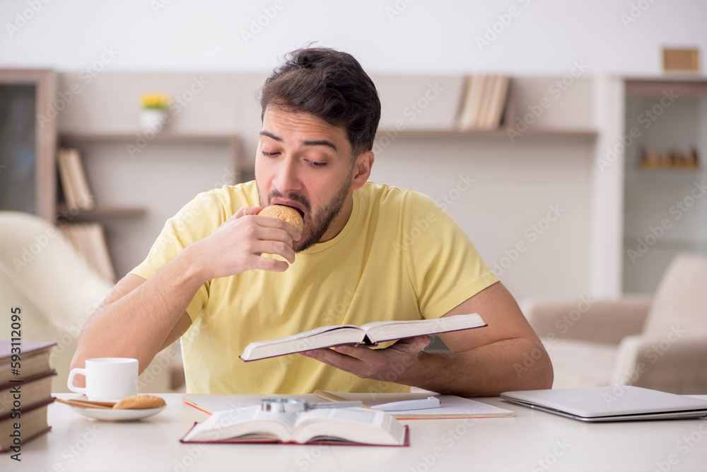 Young male student studying at home Young male student studying at home