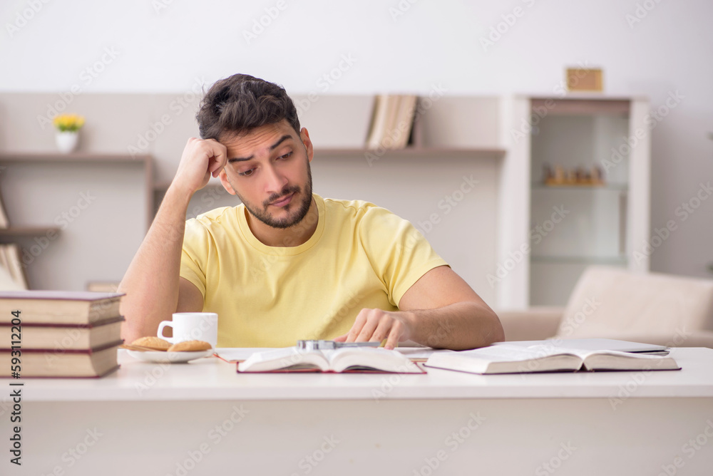 Young male student studying at home Young male student studying at home