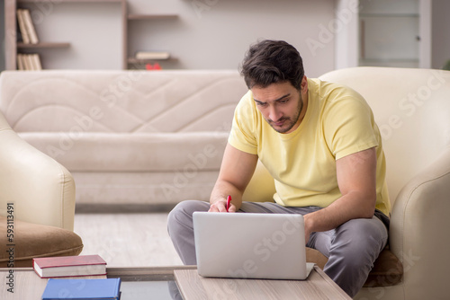 Young man working from home during pandemic © Elnur