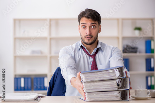 Young male employee sitting at workplace © Elnur