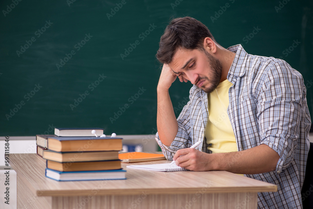 Young male physicist student in the classroom Young male physicist student in the classroom