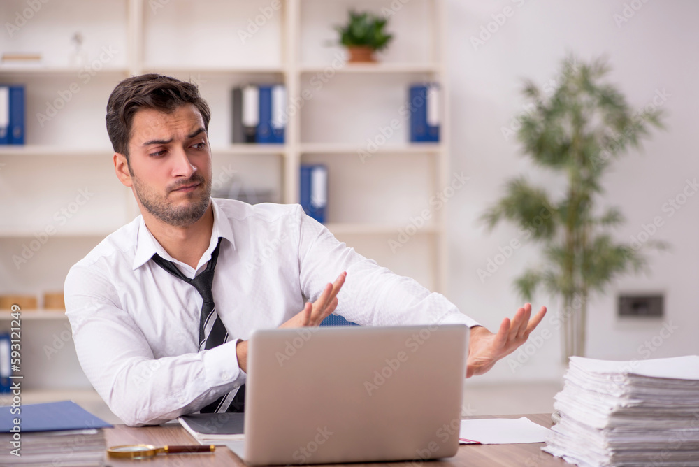 Young male employee working in the office Young male employee working in the office