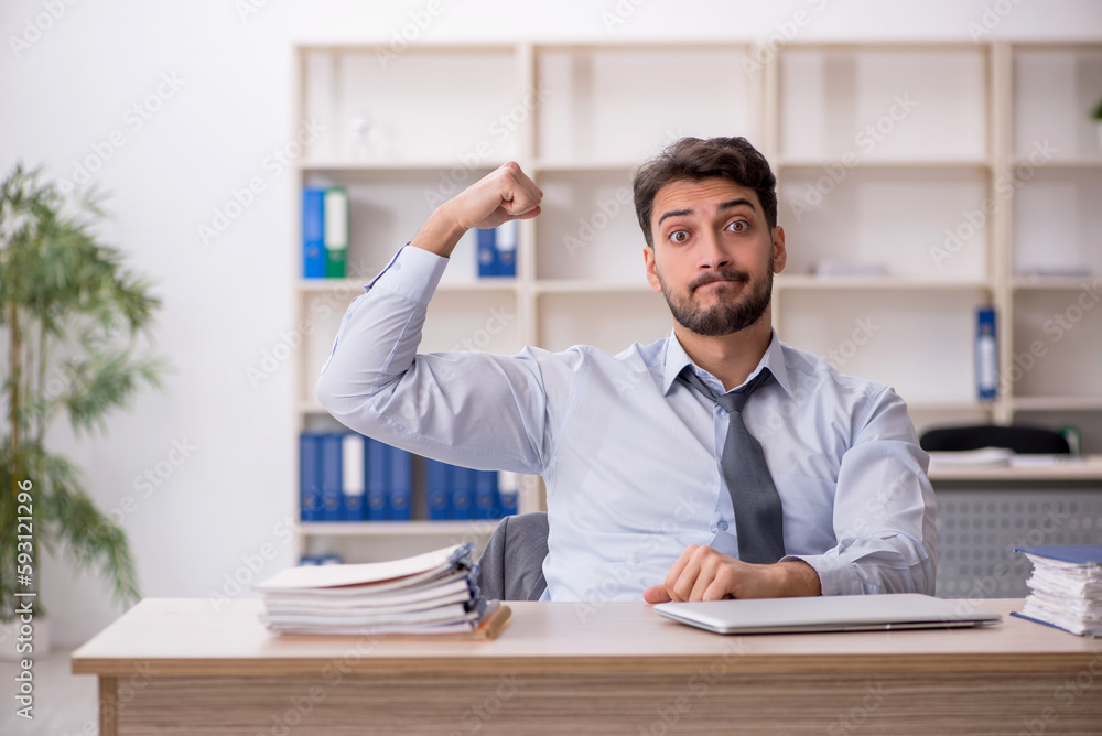 Young male employee working in the office Young male employee working in the office