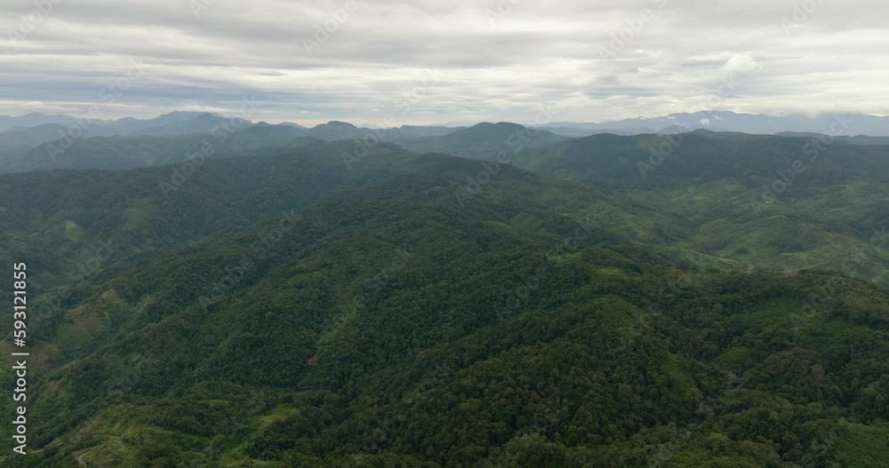 Top view of mountains and hills with green forest and trees in the tropics. Sumatra, Indonesia. Top view of mountains and hills with green forest and trees in the tropics. Sumatra, Indonesia.