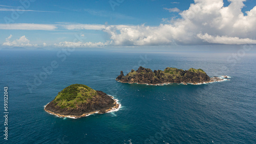 Top view of rocky tropical island in the blue ocean. Dos Hermanos Island. Santa Ana, Cagayan. Philippines. photo