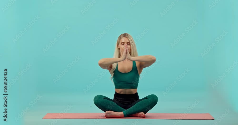 Fitness, woman and yoga mediation in studio on mat for workout or exercise against a blue background. Portrait of happy female yogi meditating for spiritual wellness on floor for exercising on mockup Fitness, woman and yoga mediation in studio on mat for workout or exercise against a blue background. Portrait of happy female yogi meditating for spiritual wellness on floor for exercising on mockup