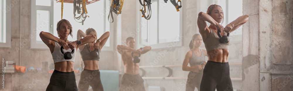 Fototapeta premium Caucasian young people exercising in fitness center