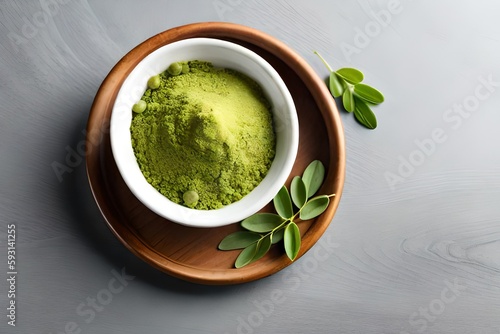 Moringa powder (Moringa Oleifera) in wooden bowl with original fresh Moringa leaves isolated on gray background. Healthy product, superfood, vitamin