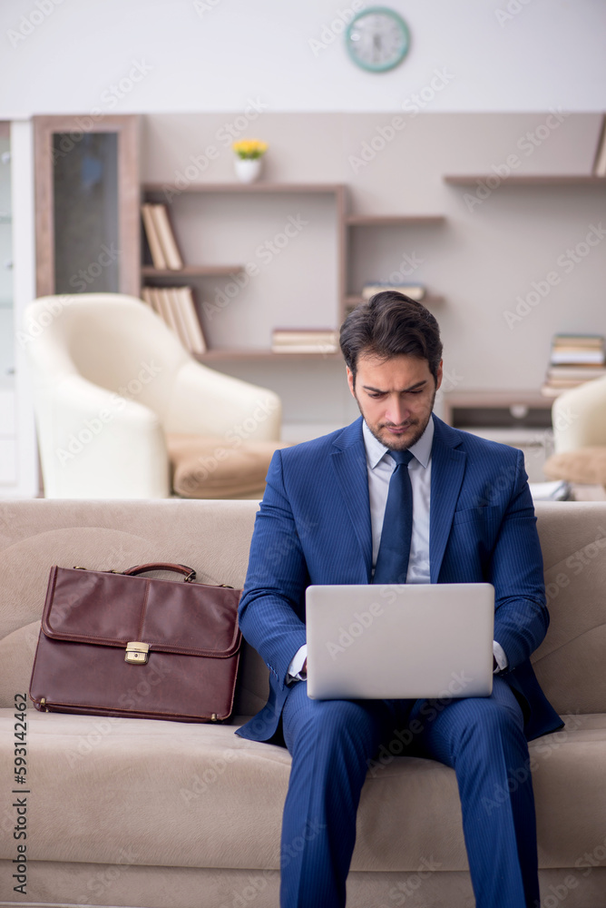 Young male employee working from home during pandemic Young male employee working from home during pandemic