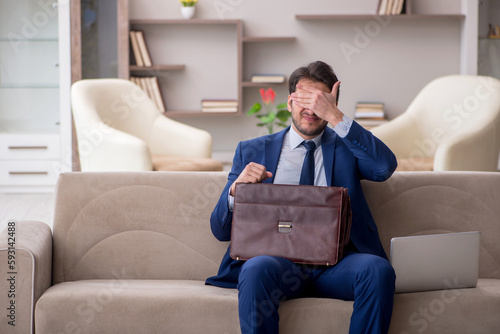 Young male employee working from home during pandemic