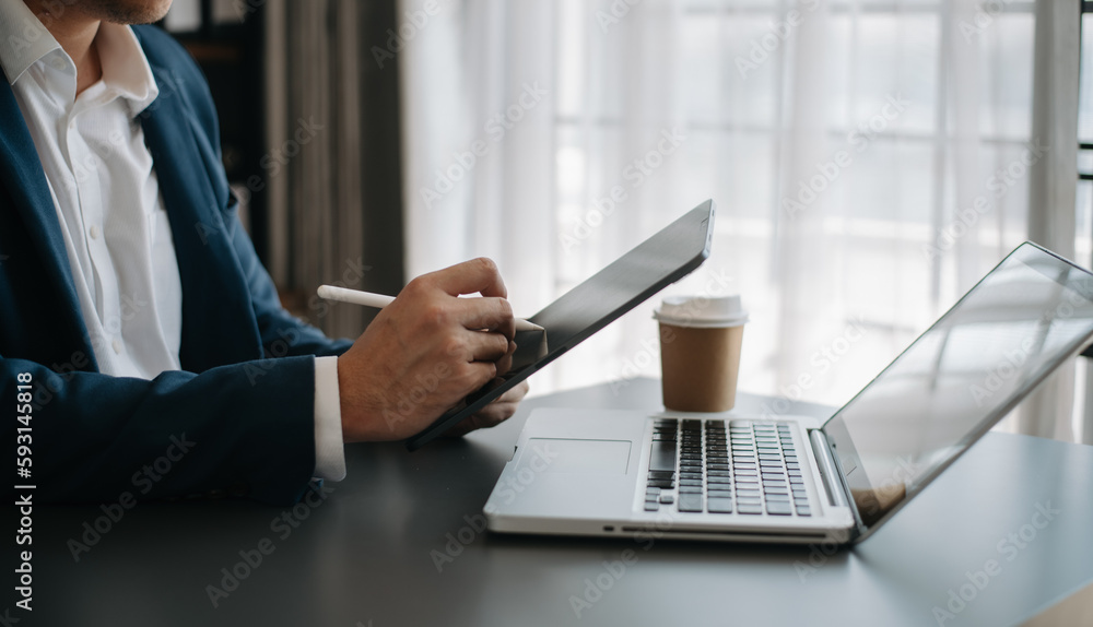 Businessman hand using smart phone laptop and tablet with social network diagram on desk as concept Businessman hand using smart phone laptop and tablet with social network diagram on desk as concept