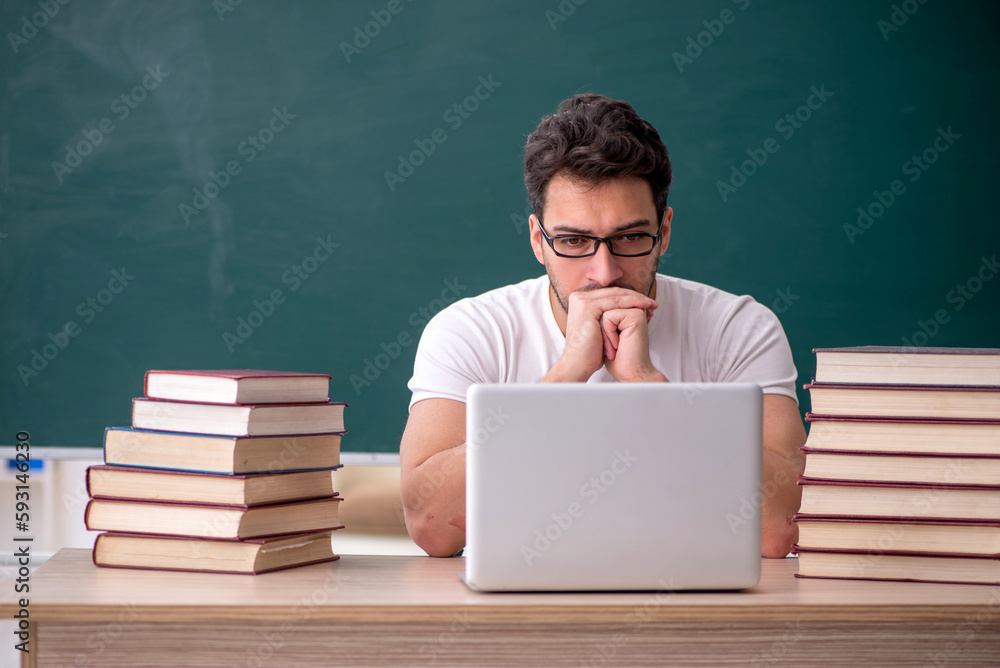 Young male student sitting in the classroom Young male student sitting in the classroom