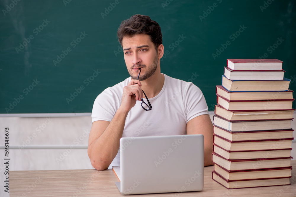 Young male student sitting in the classroom Young male student sitting in the classroom