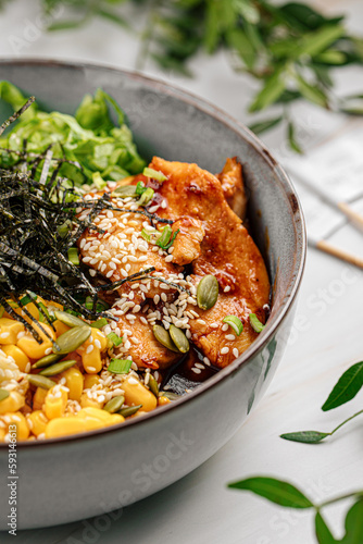 Portion of gourmet fried chicken poke bowl with vegetables