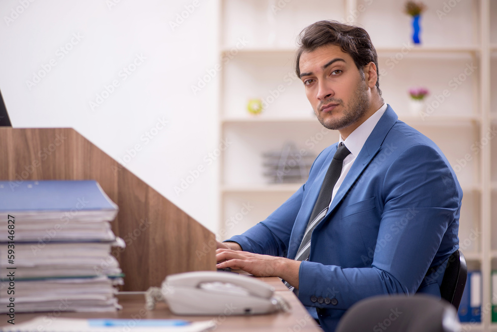 Young male employee working in the office