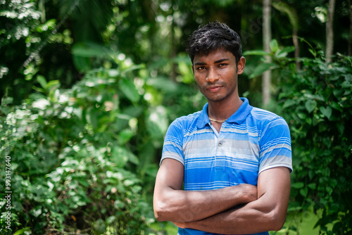 Konstfotografi Portrait of a south asian young black village boy standing within nature