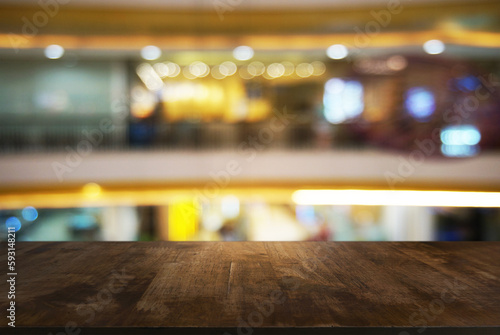 Empty wooden table in front of abstract blurred background of coffee shop . can be used for display Mock up  of product © Charlie's