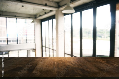 Empty wooden table in front of abstract blurred background of coffee shop . can be used for display or montage your products.Mock up for display of product © Charlie's