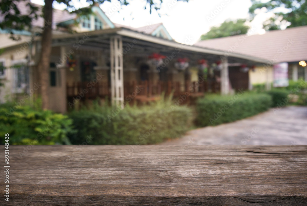 image of wooden table in front of abstract blurred background of outdoor garden lights. can be used for display or montage your products.Mock up for display of product. image of wooden table in front of abstract blurred background of outdoor garden lights. can be used for display or montage your products.Mock up for display of product.