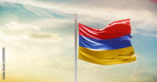 Armenia national flag waving in beautiful sky. The symbol of the state on wavy silk fabric.