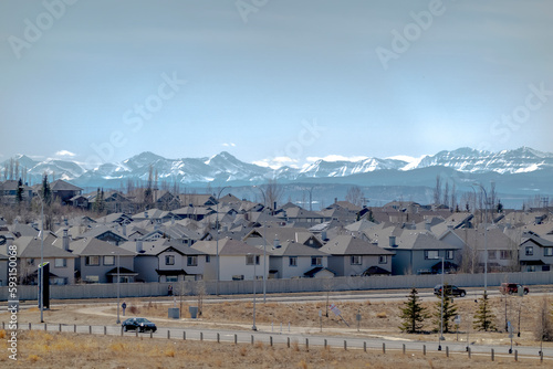 The neighbourhood of Evaston in Calgary Alberta Canada, with the Rocky Mountains on the background. Concept: Alberta real estate house market.